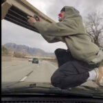 Utah man arrested after allegedly posting viral video of him riding hood of car on interstate