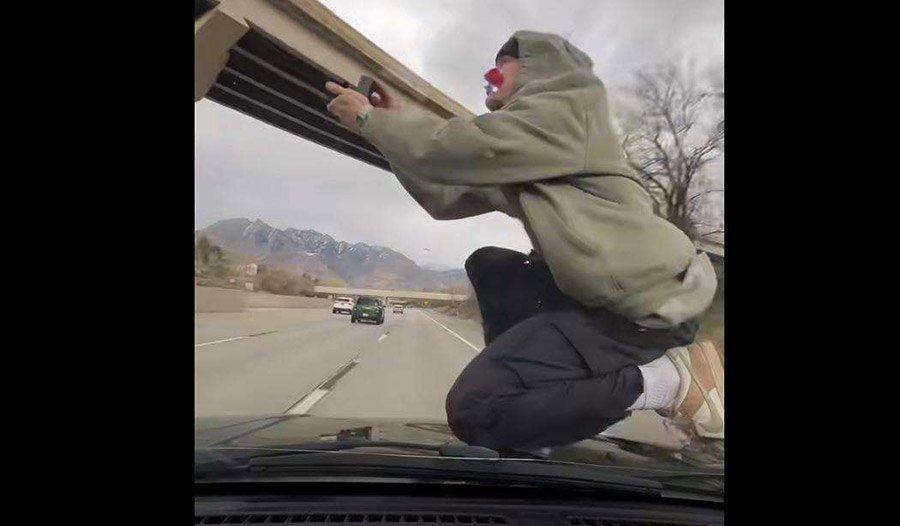 Utah man arrested after allegedly posting viral video of him riding hood of car on interstate